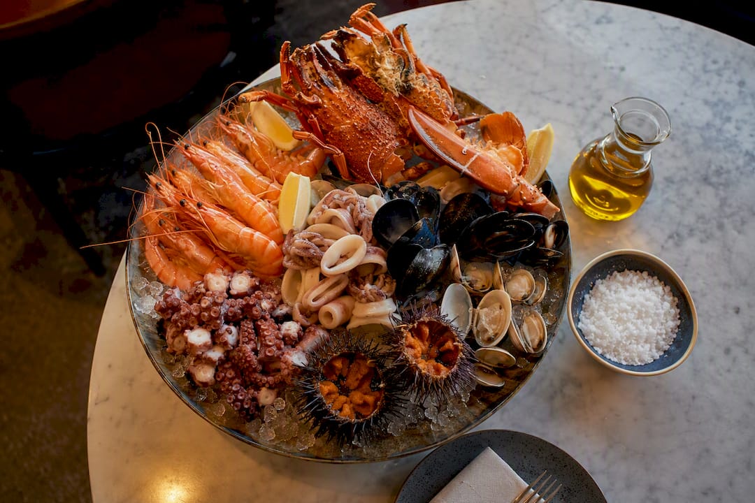 Selección de mariscos frescos dispuesta sobre una mesa de cocina rústica